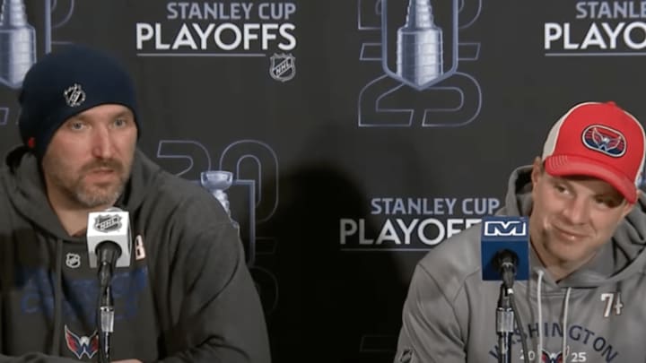 Ovechkin speaks to reporters alongside teammate John Carlson.