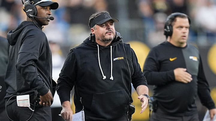 Charlotte, North Carolina, USA; Appalachian State Mountaineers head coach Dowell Logains reacts to a call during the first quarter against the Charlotte 49ers at Bank of America Stadium. Charlotte, North Carolina, USA; Appalachian State Mountaineers head coach Dowell Logains reacts to a call during the first quarter against the Charlotte 49ers at Bank of America Stadium.