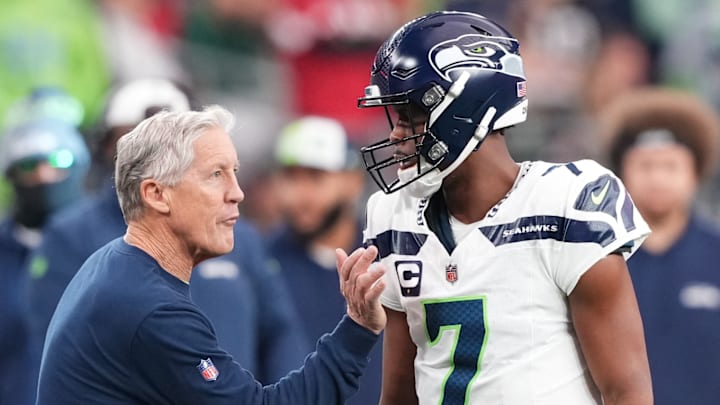 Jan 7, 2024; Glendale, Arizona, USA; Seattle Seahawks head coach Pete Carroll talks with Seattle Seahawks quarterback Geno Smith (7) during the first half of the game against the Arizona Cardinals at State Farm Stadium.