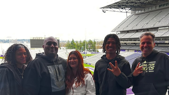 CJ Lavender and his family share a moment with UW coach Jedd Fisch.