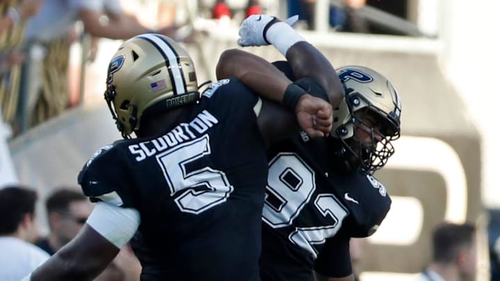 Purdue Boilermakers linebacker Nic Scourton (5) and Purdue Boilermakers defensive lineman Mo Omonode