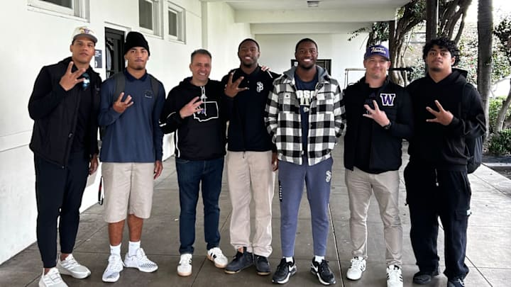 The Coach twins, third and fourth from right, pose with UW coaches and Bosco teammates. 