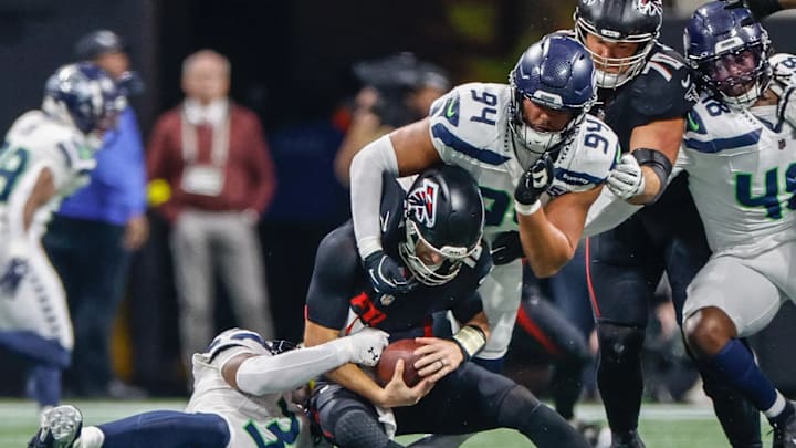 Seahawks safety Nick Emmanwori (3) gets to Kirk Cousins, and Mike Morris (94) finishes him off for an 8-yard sack in the fourth quarter Sunday. Seahawks safety Nick Emmanwori (3) gets to Kirk Cousins, and Mike Morris (94) finishes him off for an 8-yard sack in the fourth quarter Sunday.