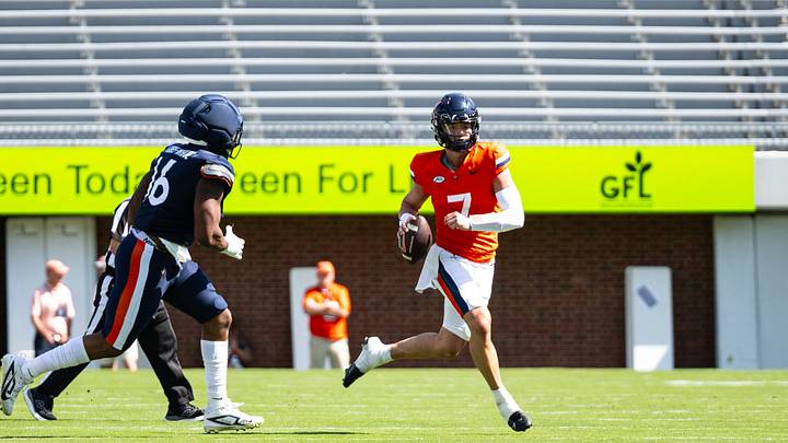 Virginia Cavaliers quarterback Beau Pribula (7) evades the pass rush from defensive end Matthew Fobbs-White (16) at Virginia's Spring Game at Scott Stadium April 18. Virginia Cavaliers quarterback Beau Pribula (7) evades the pass rush from defensive end Matthew Fobbs-White (16) at Virginia's Spring Game at Scott Stadium April 18.