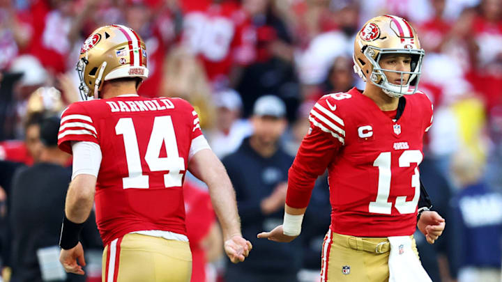 Dec 17, 2023; Glendale, Arizona, USA; San Francisco 49ers quarterback Brock Purdy (13) greets quarterback Sam Darnold (14) as he comes back into the game after an injury during the first half against the Arizona Cardinals at State Farm Stadium. 