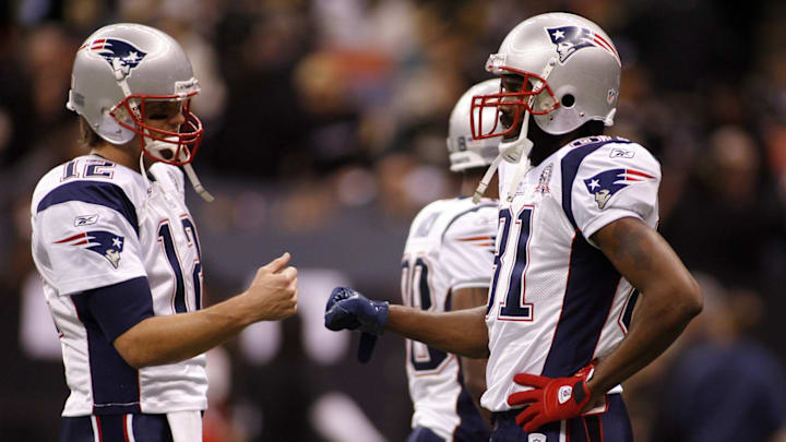 Nov. 30, 2009; New Orleans, LA, USA; New England Patriots quarterback Tom Brady (12) bump fists with wide receiver Randy Moss (81) during pregame warmups against the New Orleans Saints at the Louisiana Superdome. 