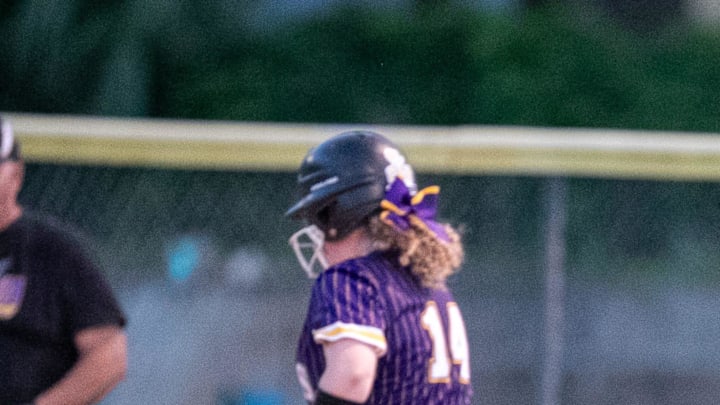 Oakleaf Charlotte Maddox (6) looks for the ball as Columbia Alex Collins (14) makes it to first during a FHSAA softball game at Columbia High School in Lake City, FL on Thursday, April 18, 2024. [Alan Youngblood/Gainesville Sun]