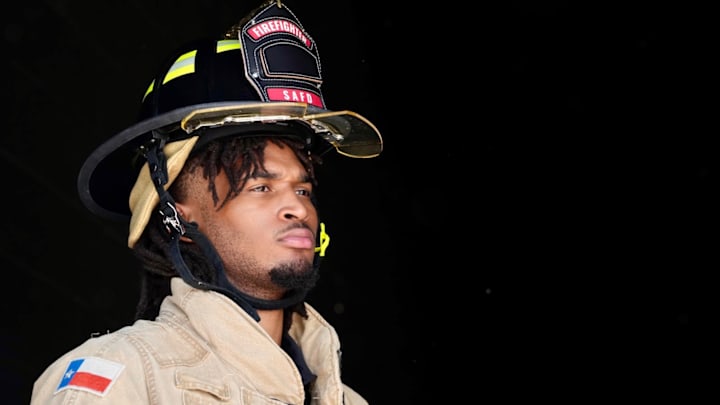 Sep 16, 2025; San Antonio, Texas, USA; San Antonio Spurs guard Stephon Castle (5) dons bunker gear during a fire safety demonstration in San Antonio in partnership with USAA. Sep 16, 2025; San Antonio, Texas, USA; San Antonio Spurs guard Stephon Castle (5) dons bunker gear during a fire safety demonstration in San Antonio in partnership with USAA.