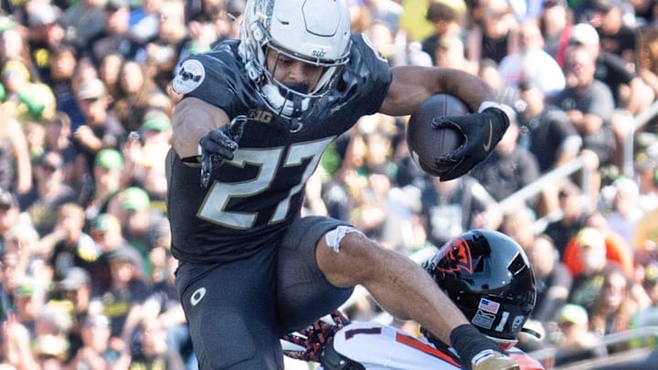 Oregon’s Jayden Limar, now at the UW, leaps over Oregon State’s Mason White. Oregon’s Jayden Limar, now at the UW, leaps over Oregon State’s Mason White.