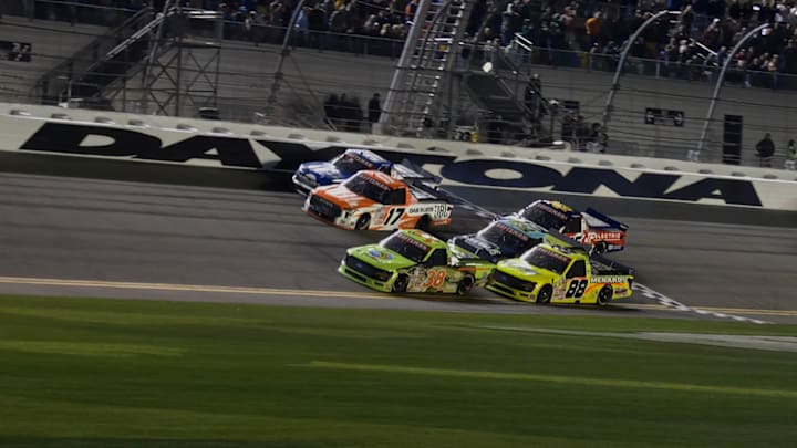 Chandler Smith took the win in a wild wad of trucks that crossed the line at the front of the field in Friday night's NASCAR Truck Series Fresh From Florida 250 at Daytona.