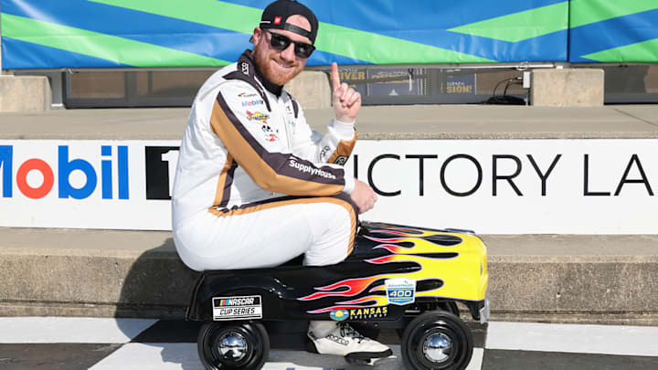 Tyler Reddick rides the pedal-car, which is given out to the polesitter at Kansas Speedway, following his pole-winning run for the 2026 AdventHealth 400.