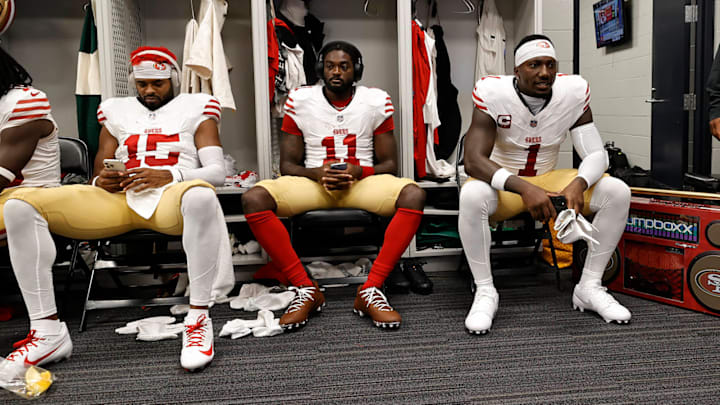 Jauan Jennings, Brandon Aiyuk and Deebo Samuel sit in the 49ers' locker room before a matchup against the Vikings at U.S. Bank Stadium.