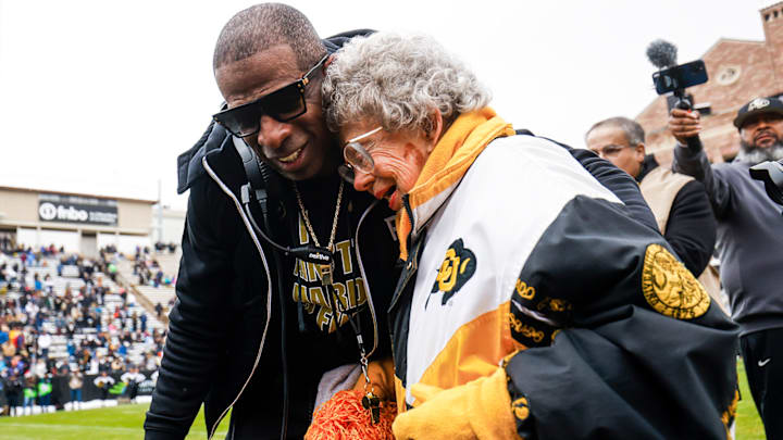 Deion Sanders embraces Miss Peggy after a Colorado football game.
