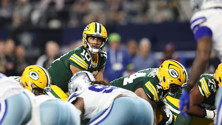Love threw for 337 yards and three touchdowns in the Packers' 40-40 tie.