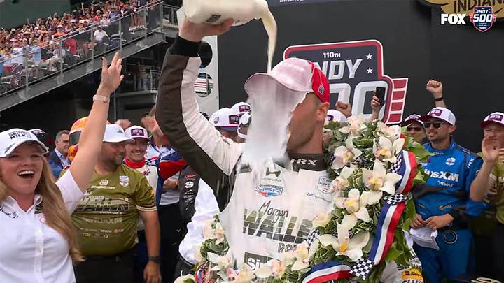 Felix Rosenqvist celebrates winning the 2026 Indy 500 with a cold bottle of milk.