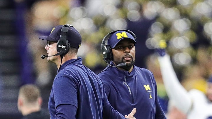 Michigan coach Jim Harbaugh high-fives offensive coordinator Sherrone Moore after a play during the second half of U-M's 26-0 win over Iowa in the Big Ten championship game in Indianapolis on Saturday, Dec. 2, 2023.