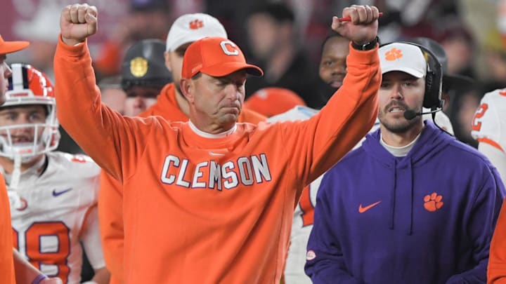 Nov 25, 2023; Columbia, South Carolina, USA; Clemson Tigers head coach Dabo Swinney celebrates with offensive coordinator Garrett Riley as time expires against the South Carolina Gamecocks at Williams-Brice Stadium.  Clemson won 16-7. Mandatory Credit: Ken Ruinard-Imagn Images