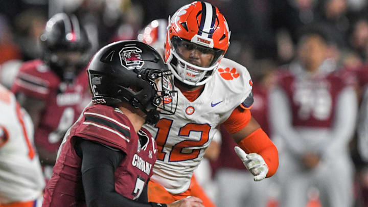 Nov 25, 2023; Columbia, South Carolina, USA; Clemson Tigers defensive lineman T.J. Parker (12) tackles South Carolina quarterback Spencer Rattler (7) during the fourth quarter at Williams-Brice Stadium. 