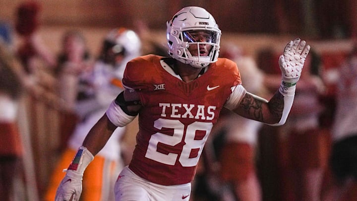 Texas Longhorns defensive back Jerrin Thompson (28) celebrates after scoring a touchdown after intercepting the ball from Wyoming Cowboys wide receiver Ayir Asante (5) during the Texas Longhorns' game against the Wyoming Cowboys, Saturday, Sept. 16 at Darrell K Royal   Texas Memorial Stadium in Austin. Thompson went on to score a touchdown.