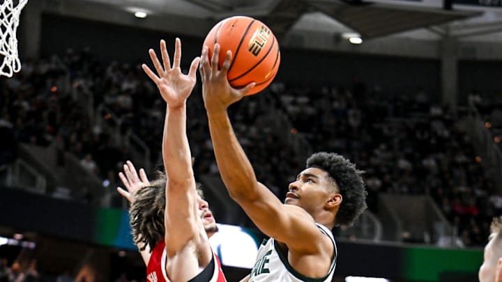 Michigan State's Jaden Akins, right, scores as Nebraska's Braxton Meah defends during the first half on Saturday, Dec. 7, 2024, at the Breslin Center in East Lansing.
