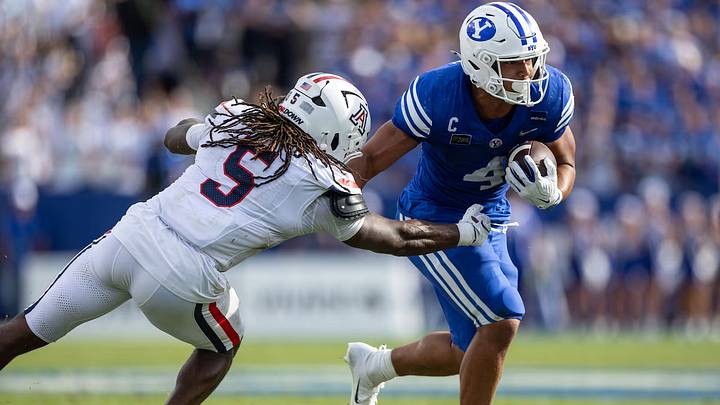 A BYU ball carrier attempts to evade an Arizona defender at LaVell Edwards Stadium. 