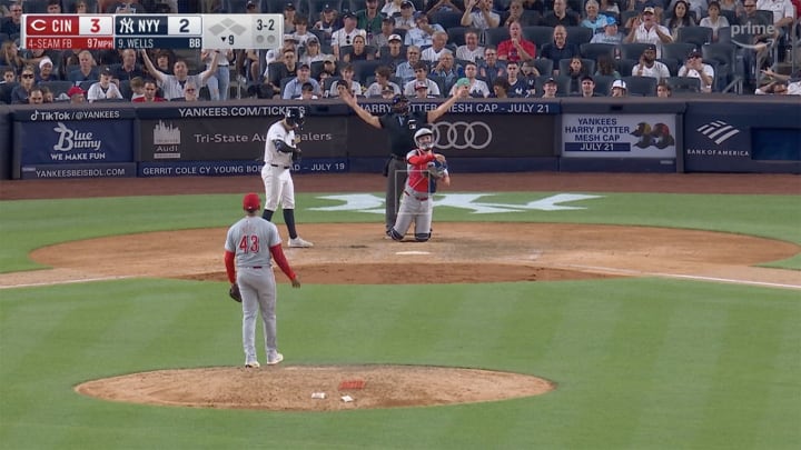 Home plate umpire Jim Wolf reacts to Reds closer Alexis Diaz being upset with one of his calls.