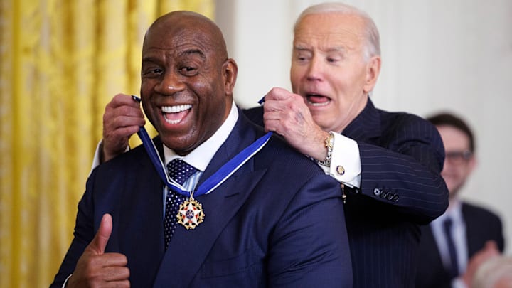 Former NBA player Earvin "Magic" Johnson gestures while receiving the Presidential Medal of Freedom from U.S. President Joe Biden in the east room of the White House.