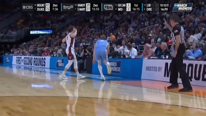 Kevin Harlan deflects the basketball during the first half of a first-round matchup between North Carolina and Ole Miss.