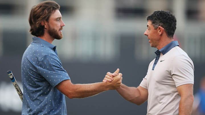 Tommy Fleetwood and Rory McIlroy shake hands on the 18th green  at Emirates Golf Club on day two of the Hero Dubai Desert Classic on Jan. 17, 2025.