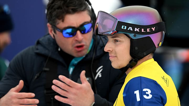 Pare speaks to an official after being disqualified following a review in the men's snowboard cross quarterfinals.