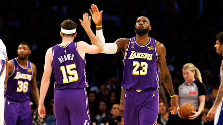 LeBron James and Austin Reaves celebrate after a play against the 76ers.