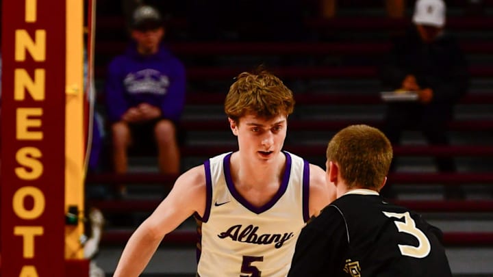 Albany boys basketball junior Braeden Justin plays defense during the 2025 Minnesota state tournament semifinal against Caledonia on March 21, 2025 at Williams Arena in Minneapolis. The Huskies won 59-54.