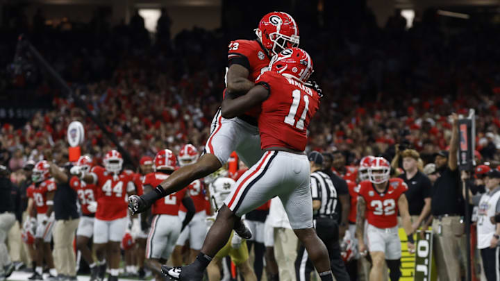 Jan 2, 2025; New Orleans, LA, USA; Georgia Bulldogs linebacker Jalon Walker (11) celebrates with Bulldogs defensive lineman Mykel Williams (13) after making a defensive stop against the Notre Dame Fighting Irish during the first quarter at Caesars Superdome.