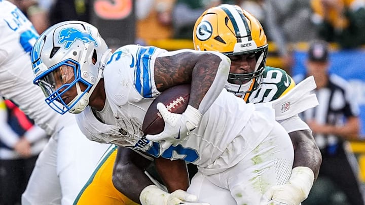Detroit Lions running back David Montgomery (5) is stopped by Green Bay Packers linebacker Edgerrin Cooper (56) during the second half at Lambeau Field in Green Bay, Wis., on Sunday, September 7, 2025. Detroit Lions running back David Montgomery (5) is stopped by Green Bay Packers linebacker Edgerrin Cooper (56) during the second half at Lambeau Field in Green Bay, Wis., on Sunday, September 7, 2025.