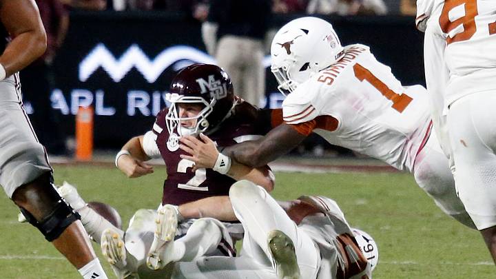 Oct 25, 2025; Starkville, Mississippi, USA; Texas Longhorns defensive linemen Ethan Burke (91) and Texas Longhorns defensive linemen Colin Simmons (1) force Mississippi State Bulldogs quarterback Blake Shapen (2) to fumble during overtime at Davis Wade Stadium at Scott Field. Mandatory Credit: Petre Thomas-Imagn Images Oct 25, 2025; Starkville, Mississippi, USA; Texas Longhorns defensive linemen Ethan Burke (91) and Texas Longhorns defensive linemen Colin Simmons (1) force Mississippi State Bulldogs quarterback Blake Shapen (2) to fumble during overtime at Davis Wade Stadium at Scott Field. Mandatory Credit: Petre Thomas-Imagn Images