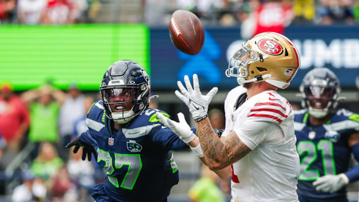 Sep 7, 2025; Seattle, Washington, USA; San Francisco 49ers wide receiver Ricky Pearsall (1) catches a pass against Seattle Seahawks cornerback Riq Woolen (27) during the fourth quarter at Lumen Field. Sep 7, 2025; Seattle, Washington, USA; San Francisco 49ers wide receiver Ricky Pearsall (1) catches a pass against Seattle Seahawks cornerback Riq Woolen (27) during the fourth quarter at Lumen Field.