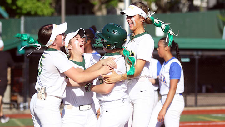 Jesuit’s (from left) Aubrey Rhodes, Selah Greene, Riley Smith and Berkleigh Tuck celebrate following Smith’s game-ending RBI single in the Crusaders’ 10-0 state playoff win over Aloha.
