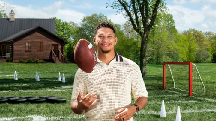 Patrick Mahomes tosses a football in the air.