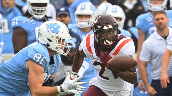 Oct 1, 2022; Chapel Hill, North Carolina, USA; North Carolina Tar Heels tight end John Copenhaver (81) makes a catch Virginia Tech Hokies linebacker Keli Lawson (21) defends in the first quarter at Kenan Memorial Stadium. Mandatory Credit: Bob Donnan-USA TODAY Sports