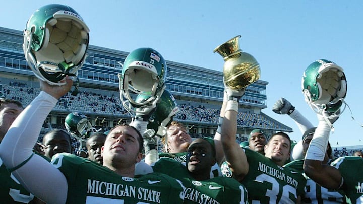 Oct 29, 2005; East Lansing, MI, USA; The Michigan State Spartans celebrate with the Old Brass Spittoon after a victory against Indiana Hoosiers at Spartan Stadium. Spartans beat the Hoosiers 46-15. Mandatory Credit: Photo By Matthew Emmons- Imagn Images Oct 29, 2005; East Lansing, MI, USA; The Michigan State Spartans celebrate with the Old Brass Spittoon after a victory against Indiana Hoosiers at Spartan Stadium. Spartans beat the Hoosiers 46-15. Mandatory Credit: Photo By Matthew Emmons- Imagn Images