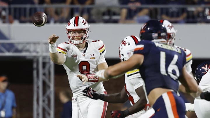 Sep 14, 2024; Charlottesville, Virginia, USA; Maryland Terrapins quarterback Billy Edwards Jr. (9) passes the ball to Terrapins running back Roman Hemby (24) as Virginia Cavaliers linebacker Trey McDonald (16) during the first half at Scott Stadium. Mandatory Credit: Geoff Burke-Imagn Images