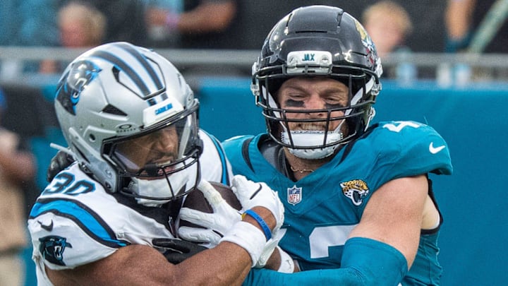 Jacksonville Jaguars safety Andrew Wingard (42) tries to strip the ball from Carolina Panthers running back Chuba Hubbard (30) during the fourth quarter of an NFL football game between the Carolina Panthers at Jacksonville Jaguars at EverBank Stadium Sunday September 7, 2025. Jaguars defeated the Panthers 26-10. [Doug Engle/Florida Times-Union]