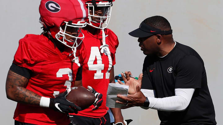 Georgia running backs Josh Crawford works with Georgia running backs Andrew Paul (3) and Georgia running back Len'Neth Whitehead (41) during spring practice in Athens, Ga., on Thursday, March 14, 2024.