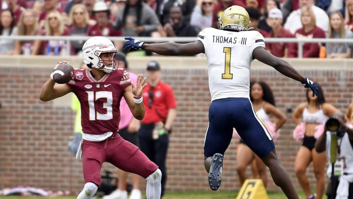 Oct 29, 2022; Tallahassee, Florida, USA; Florida State Seminoles quarterback Jordan Travis (13) is pressured by Georgia Tech Yellow Jackets linebacker Charlie Thomas (1)  during the first half at Doak S. Campbell Stadium. Mandatory Credit: Melina Myers-USA TODAY Sports
