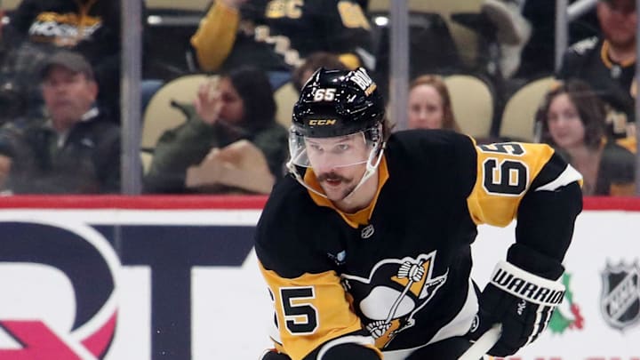 Nov 27, 2024; Pittsburgh, Pennsylvania, USA;  Pittsburgh Penguins defenseman Erik Karlsson (65) skates up ice with the puck against the Vancouver Canucks during the third period at PPG Paints Arena. Mandatory Credit: Charles LeClaire-Imagn Images