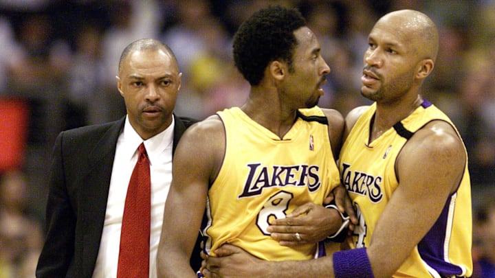 Apr 2, 2000; Los Angeles, California, USA;  Los Angeles Lakers guard/forward Kobe Bryant is lead off the court by teammate Ron Harper (right) and assistant coach Jim Cleamons (left) after an altercation with the New York Knicks' Chris Childs (not pictured)  in the second half of the Lakers' win at the Staples Center.. Mandatory Credit: Robert Hanashiro-USA TODAY NETWORK