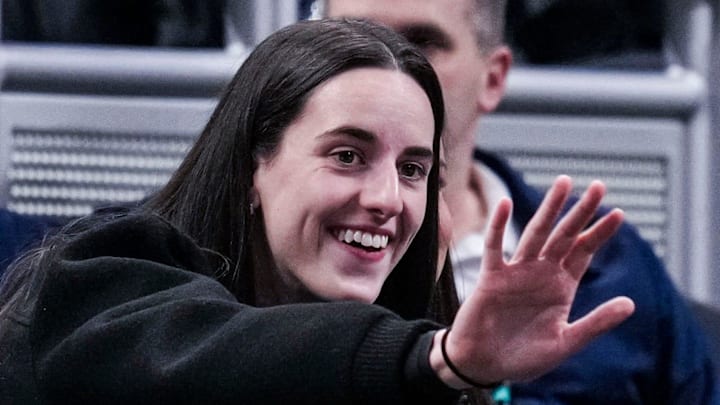 Indiana Fever guard Caitlin Clark (22) waves to her former teammates Wednesday, March 5, 2025, in a round one game at the 2025 TIAA Big Ten Women's Basketball Tournament between the Iowa Hawkeyes and the Wisconsin Badgers at Gainbridge Fieldhouse in Indianapolis.