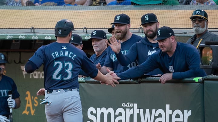 Jun 4, 2024; Oakland, California, USA; Seattle Mariners first baseman Ty France (23) celebrates with teammates after scoring against the Oakland Athletics during the third inning at Oakland-Alameda County Coliseum. Mandatory Credit: Ed Szczepanski-USA TODAY Sports