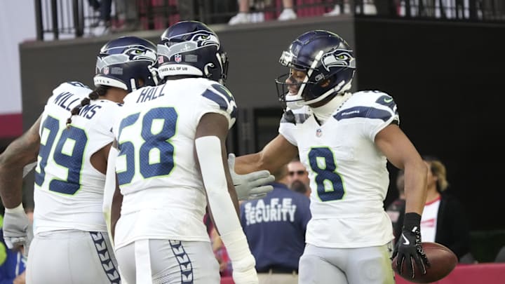 Seattle Seahawks cornerback Coby Bryant (8) celebrates after an interception against the Arizona Cardinals during the second quarter at State Farm Stadium in Glendale on Dec. 8, 2024.