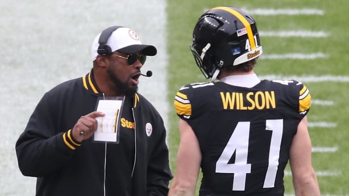 Dec 25, 2024; Pittsburgh, Pennsylvania, USA;  Pittsburgh Steelers head coach Mike Tomlin (left) talks with linebacker Payton Wilson (41) on the sidelines against the Kansas City Chiefs during the third quarter at Acrisure Stadium. Mandatory Credit: Charles LeClaire-Imagn Images